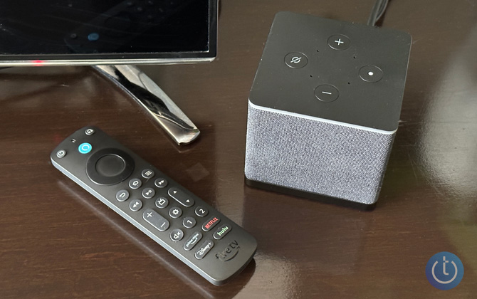 Alexa Voice Remote Pro with Fire TV Cube in front of a TV