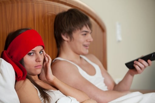 Young couple watches loud TV