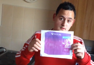 Peter Clatworthy holding a picture of an Xbox One