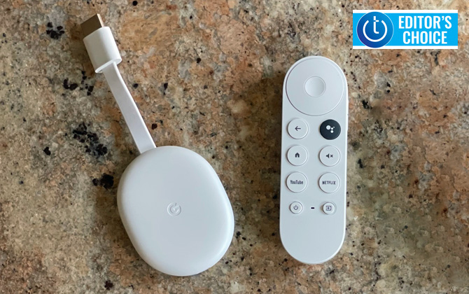 Google Chromecast with Google TV dongle and remote control on stone countertop. Techlicious Editor's Choice logo in upper right.