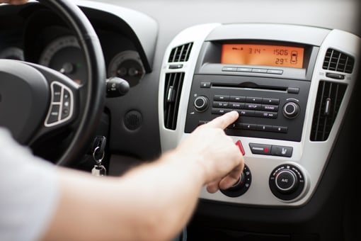 Man in car using FM radio