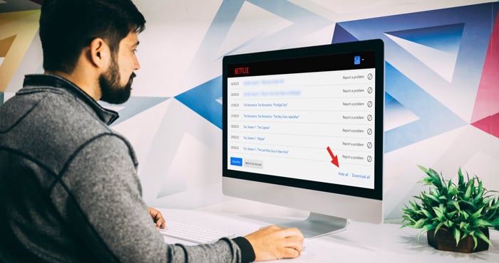 Man viewing Netflix Watch History list with an arrow pointing out the hide all option. 
