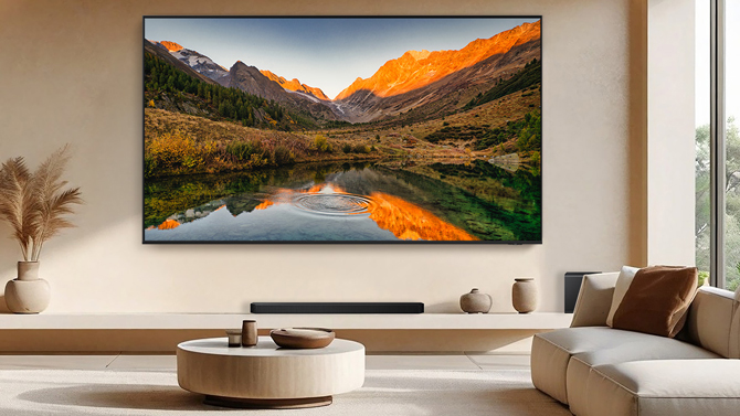Samsung 115-inch QN90F TV shown wall-mounted in a living room for scale