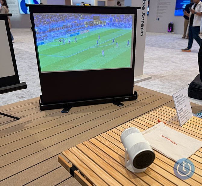 The Freestyle+ projects an images on a screen in a bright room.