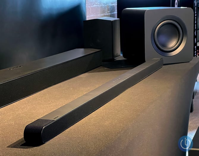 Samsung S800B Ultra-Slim soundbar shown from the right on a black surface with the subwoofer at the end and another soundbar in the background.