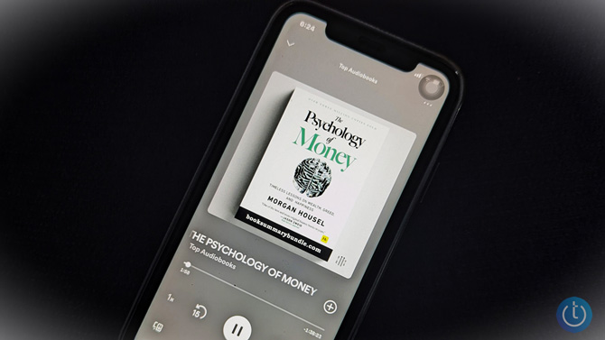 iPhone showing a screenshot of Spotify's The Psychology of Money audiobook.