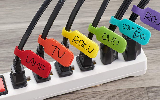Wrap-It hook-and-loop labels on black cords: from the left lamp (red), TV (orange), Roku (yellow), DVD (green), sound bar (blue). 