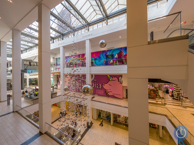 Image taken by GoPro Hero10 with ISO 100 and saved in the camera as a RAW file. The scene is looking down and across a mall courtyard with a reflective ball art installation hanging down from the ceiling.