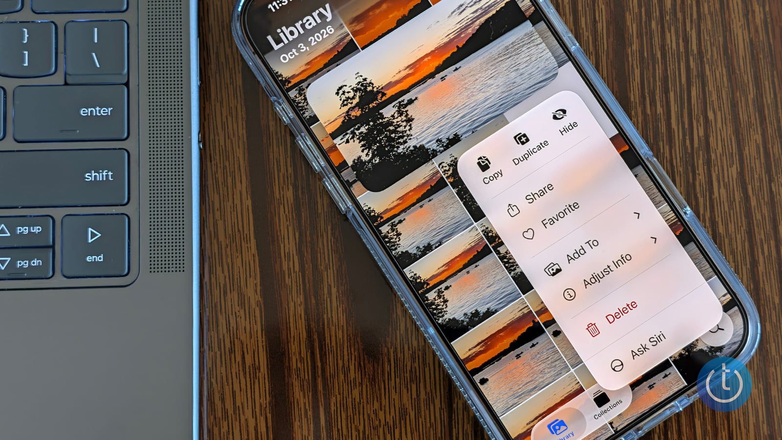 iPhone beside a laptop on a wooden desk, displaying sunset photos and an open menu with the Hide option.
