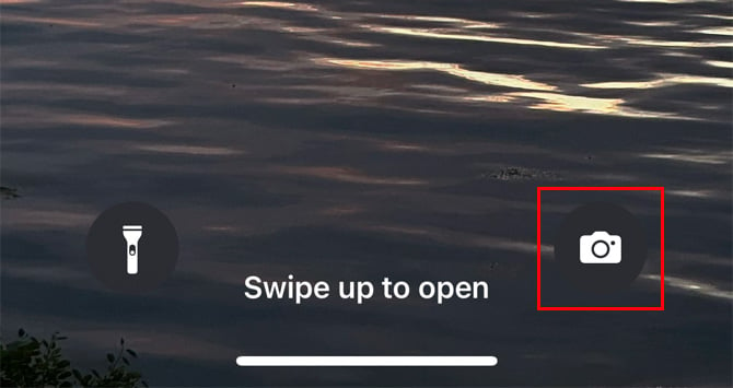 iOS lock screen showing the camera icon in red box.