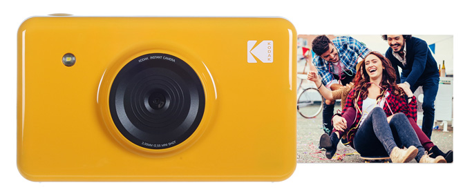 Kodak Printomatic Instant Print Camera shown from the front in orange with a print sticking