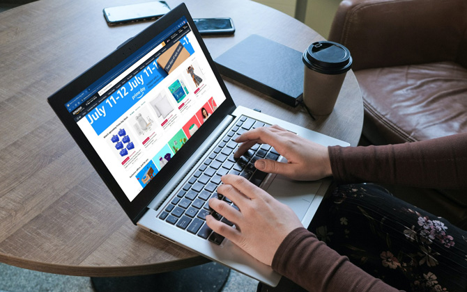  The computer screen has a screenshot of Amazon website showing Amazon Prime Day. 