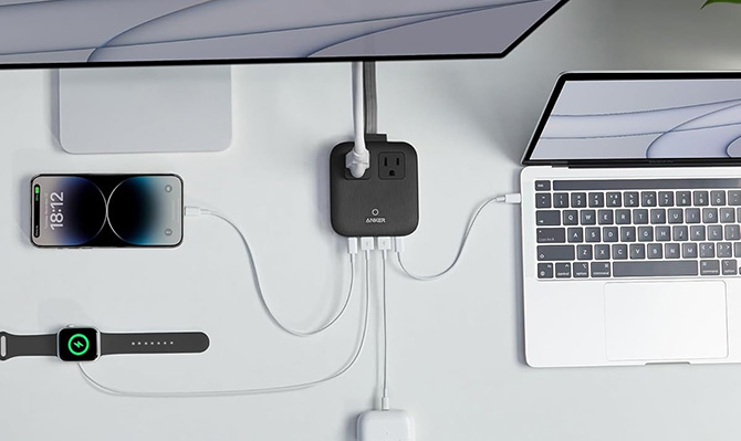 Anker Nano Power Strip with a phone, monitor, and laptop plugged in