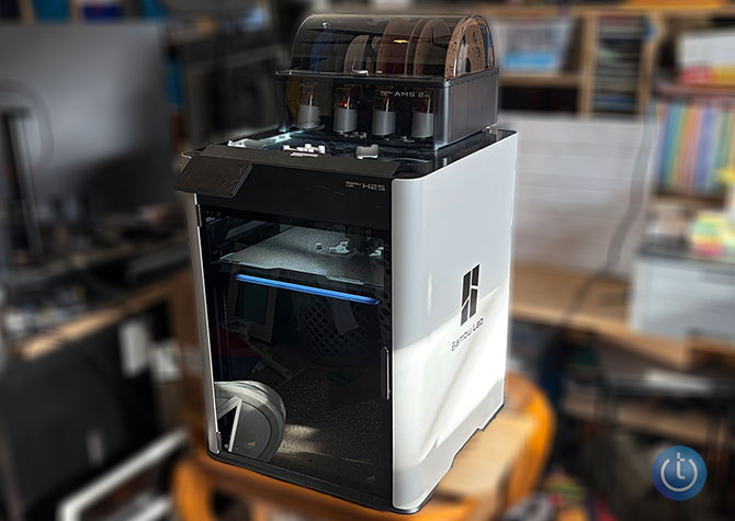 Bambu H2S printer sits on a table in the writer's office.