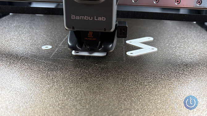 Close up of the Bambu 2HS 3D printer printing an object