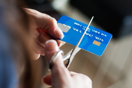 Hand cutting up a credit card