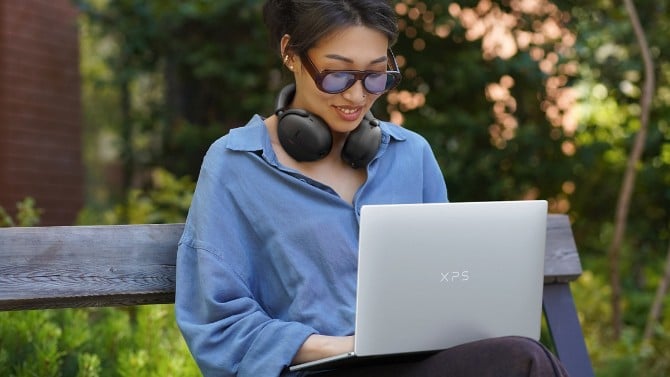 Woman sitting with a Dell XPS 13 2026