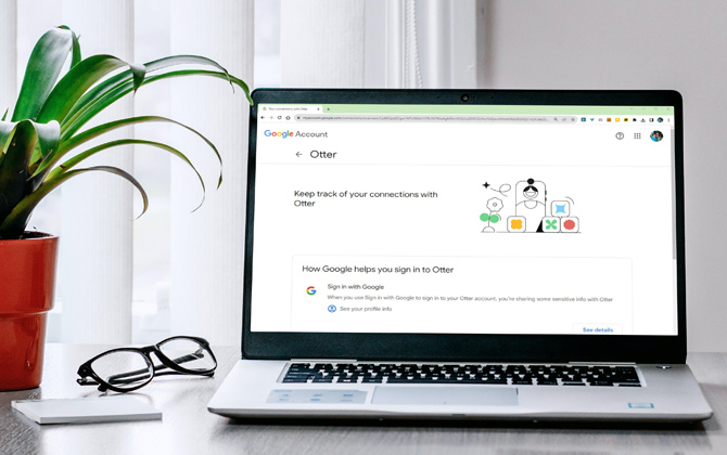 Laptop on desk with a plant and glasses. The screenshot shows the Google Account connection information to the Otter service.
