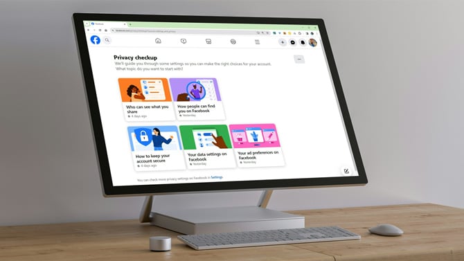 Computer monitor with screenshot of Facebook Privacy Checkup main page with tiles for Who can see what you share, How to keep your account secure, How people can find you on Facebook, Your data settings on Facebook, Your ad preferences