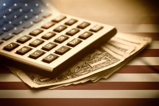 Calculator and money on U.S. flag background