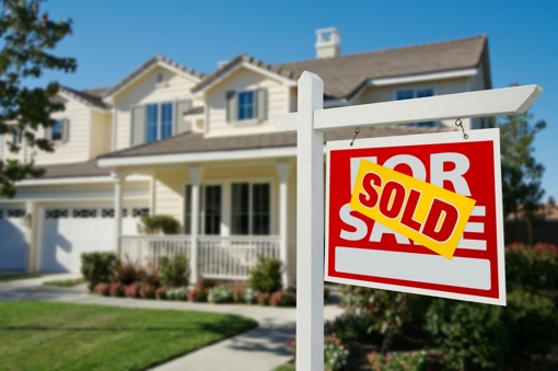 Home with Sold sign in front of it