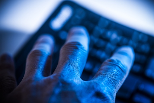 An ominous-looking hand that represents, conceptually, the theft of Internet accounts