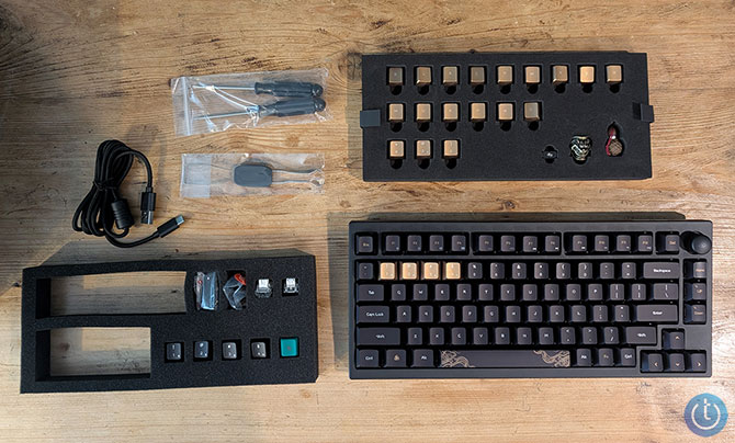 The Keychron Black Myth Wukong keyboard shown with the parts that come in the box.