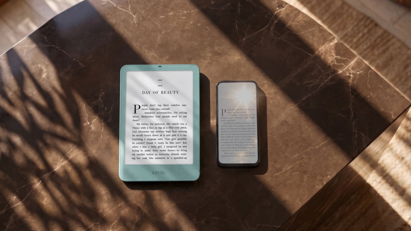 The new Kindle Paperwhite sits next to a phone showing the anti-reflective properties of the Paperwhite's display.