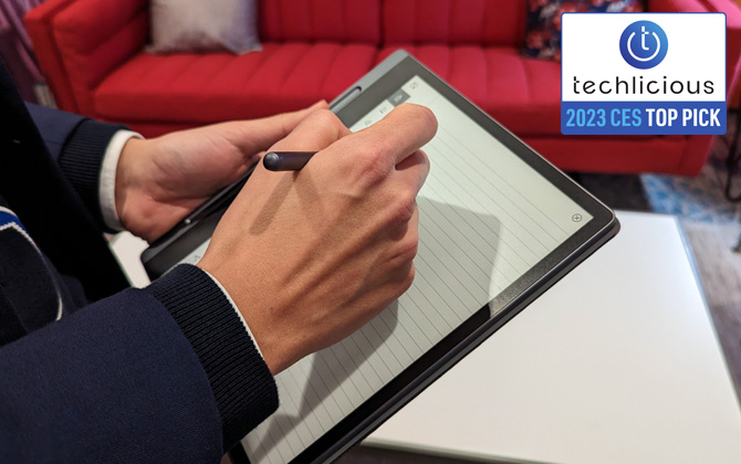 Lenovo Smart Paper held in hands with included pen