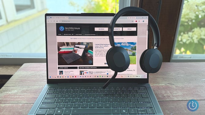 The Lenovo ThinkPad Dual-Mode 8550 headset hangs on a laptop display