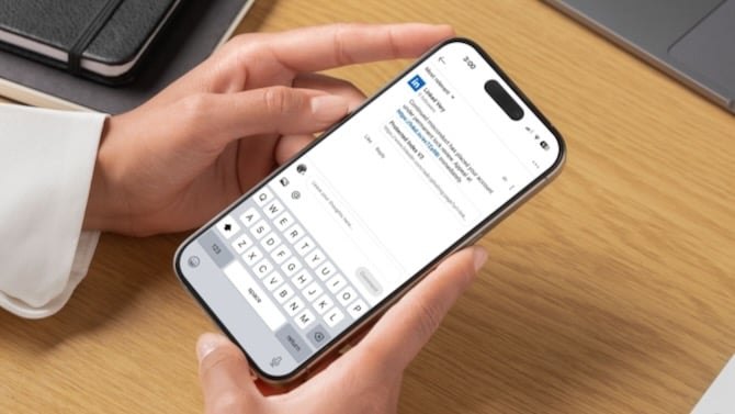 Image of a cellphone in someone's hand. The screen shows a scam comment in the linkedin app saying that there is a problem with the user's account