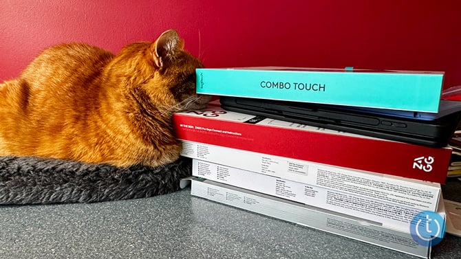 The Logitech Cpombo Touch (pointed out by my cat) sits in a stack of boxes for the other cases tested.