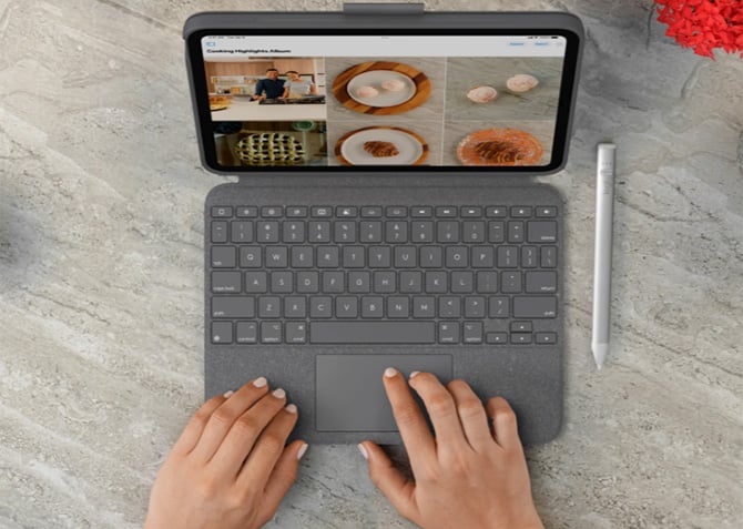 The Logitech Cpombo Touch shown with hands typing.