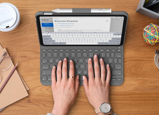 The Logitech Slim Folio Case shown with hands typing