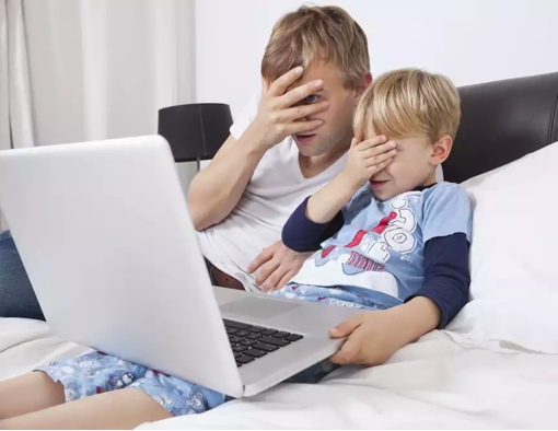 Man and child hiding eyes at the computer