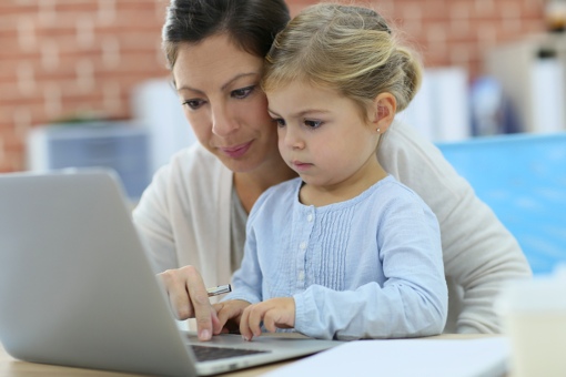 Mom and daughter using computer at home