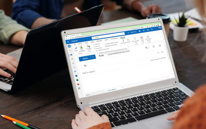 Laptop showing Outlook.com and a new message with the Options menu option with the read receipt.