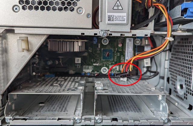 Interior of desktop computer. A free power cable is circled in red.