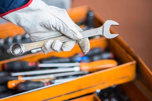 Service professional holding a wrench