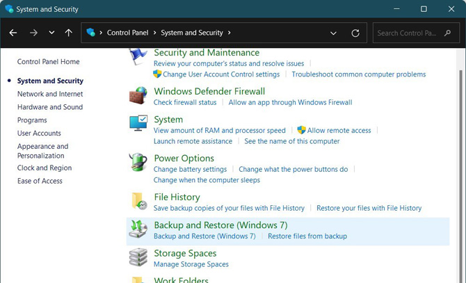 Windows Control Panel System and Security screen showing options in the right pane for Security and Maintenance, Windows Defender Firewall, System, Power Options, File History, Backup and Restore (Windows 7), Storage Spaces, Work Folders. 