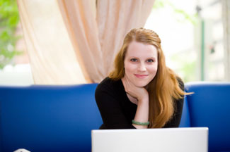 woman on sofa with computer