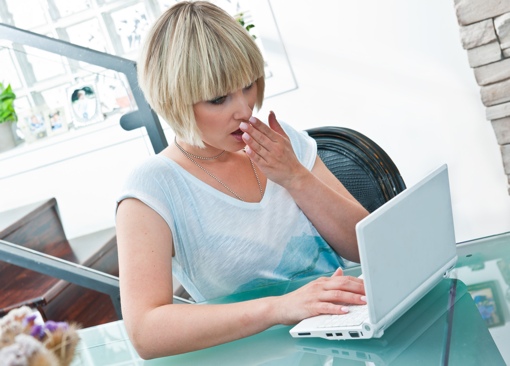 Woman surprised at her computer