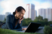 woman using a laptop in the park