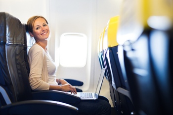 Woman using a laptop on a plane