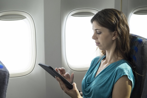 Woman with tablet on plane