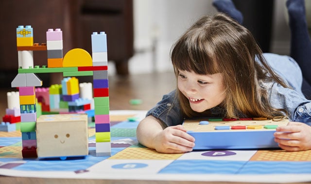 Child playing with coding toy