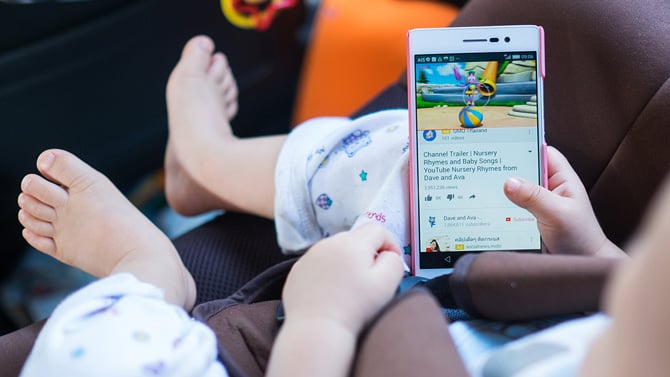 A toddler watching a trailer on YouTube