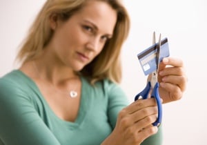 Woman cutting a credit card