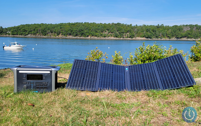 Anker 757 PowerHouse on grass connected to a solar panel.