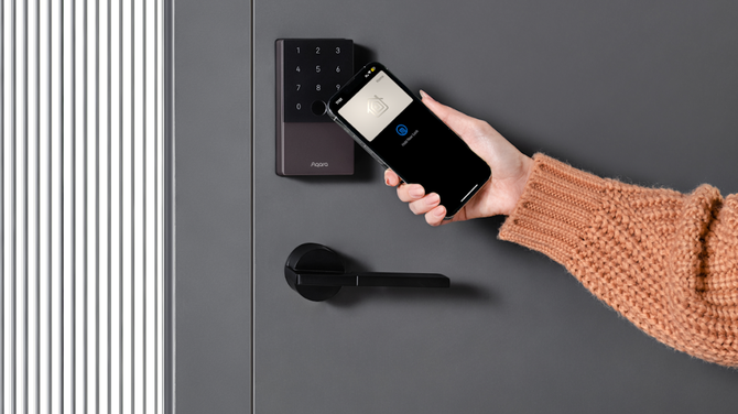 Aqara U100 samrt lock shown being unlocked with a smartphone